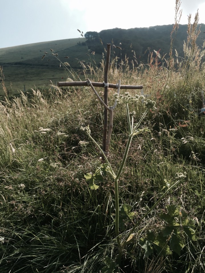 People leave homemade crosses at the top of the pass