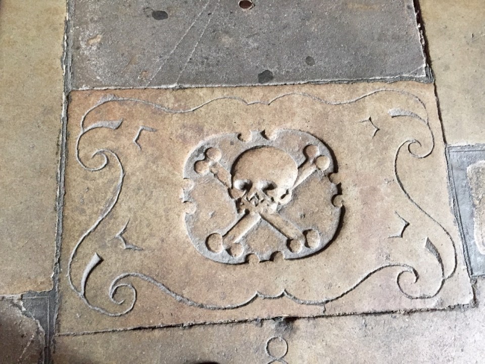 Skull and crossbones motif on cloisters flagstone