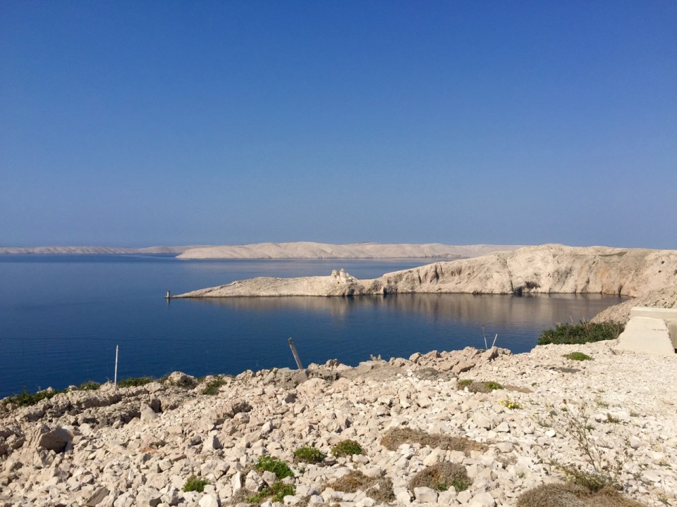 Barren landscape of Pag; near bridge to mainland, castle in background