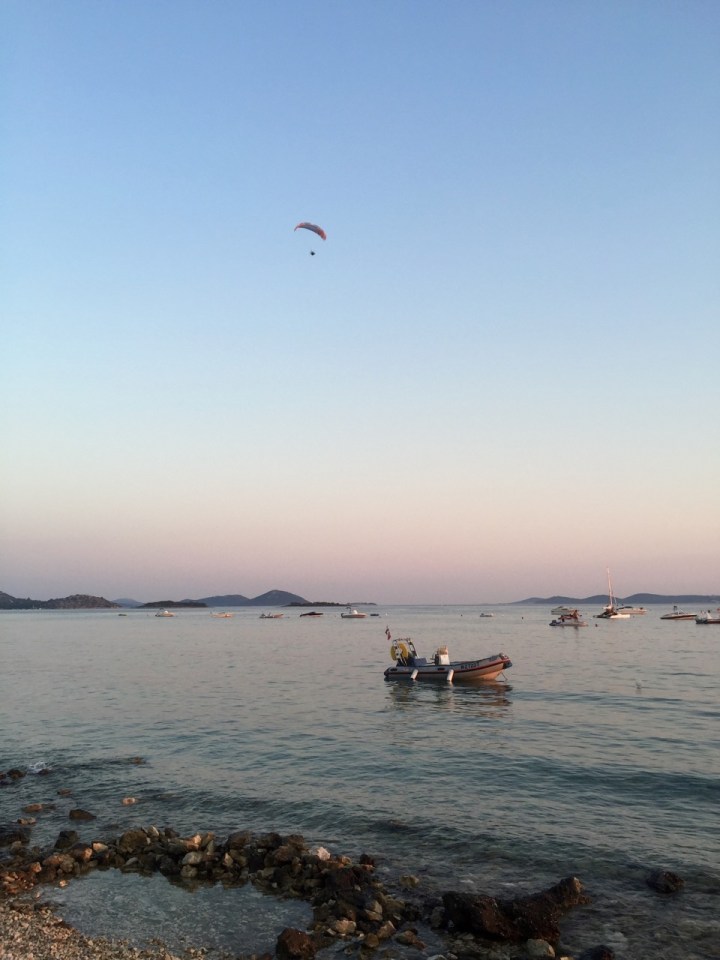 Someone paragliding as the sun sets