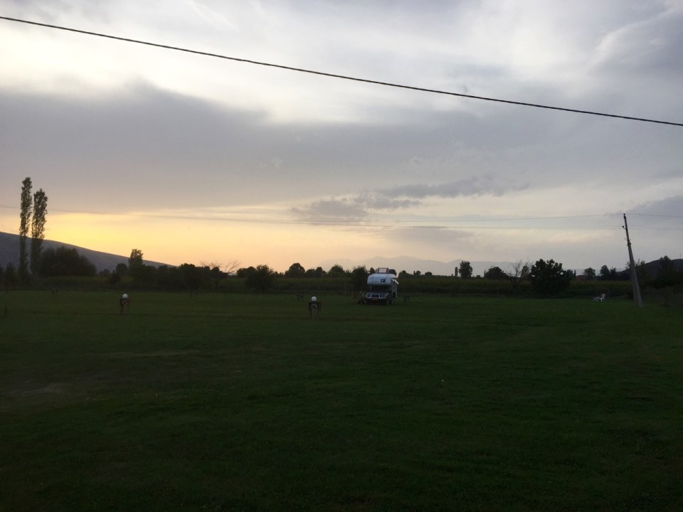 Sun sets at Camping Albania; storm clouds gathering