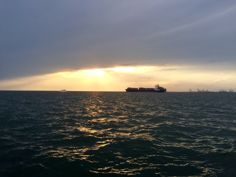 Close to sunset; cargo ship moored in bay