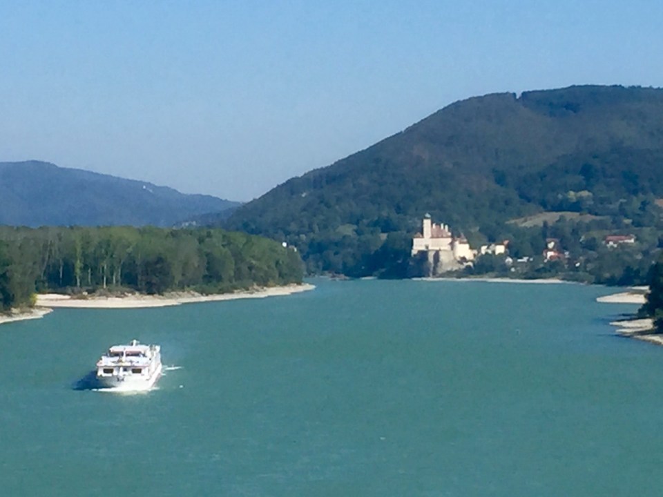 River cruiser and castle in background